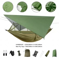 Army green stealth camping hammock set up on a white background with a green tarp above it.